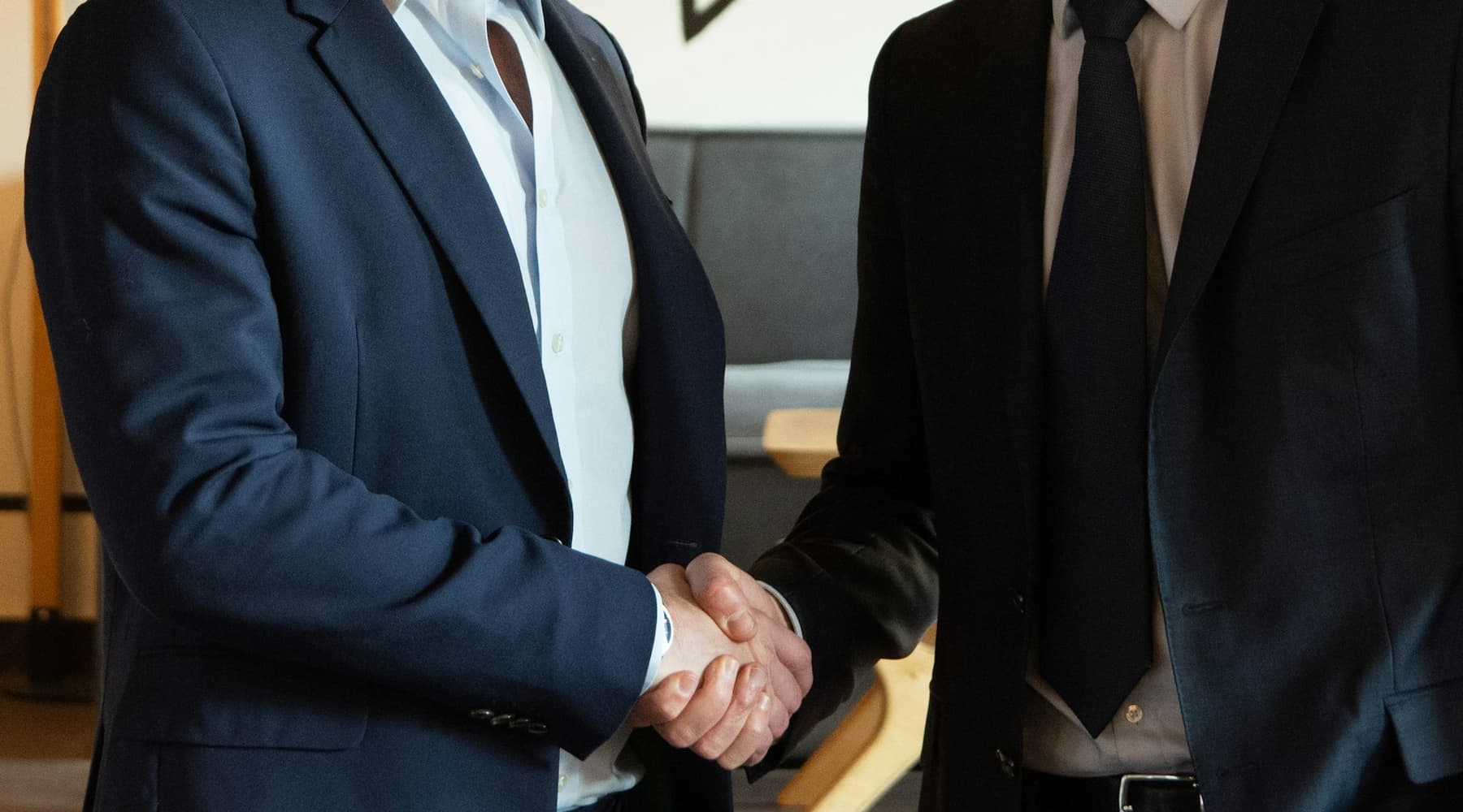 Home service business owner shaking hands with a satisfied customer